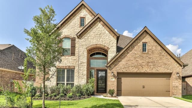 Front of two-story traditional-style house with brick and stone exterior
