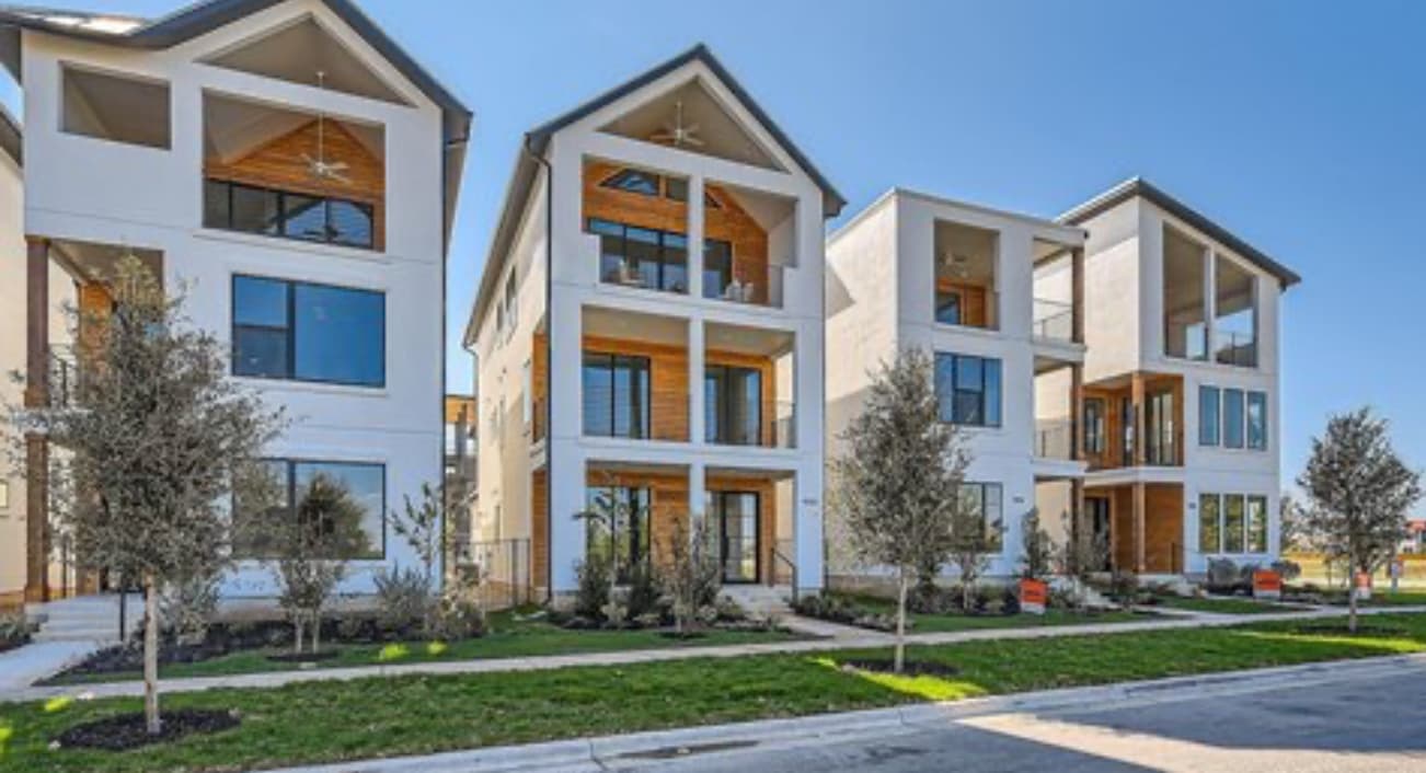 Row of three modern multi-story townhouses with contemporary design
