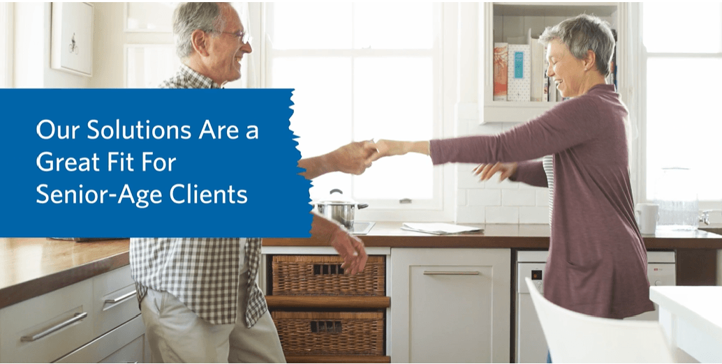 Older couple in kitchen with wooden box - Our Solutions Are a Great Fit For Senior-Age Clients